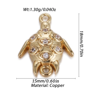 Detail of golden copper turtle pendant with cubic zirconia for DIY jewelry making