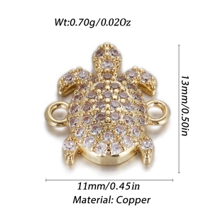 Detailed macro view of a gold-plated turtle charm with sparkling white zircons
