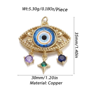 Detailed view of copper evil eye pendant with 14K gold plating and colorful charms