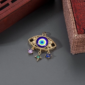 Detail of 14K gold plated evil eye pendant with colorful zirconia star and drop charms