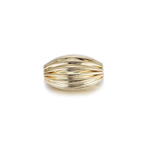 Detailed view of oval gold-plated corrugated bead with horizontal textured stripes