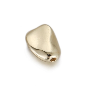 Close-up of golden geometric pebble bead with smooth metallic finish for DIY jewelry