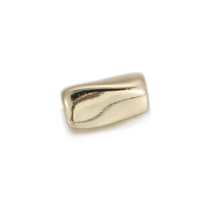 Close-up of heart-shaped gold plated bead charm with zircon for DIY jewelry making