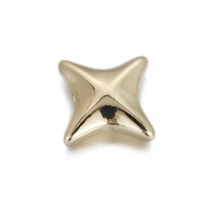 Close-up of a polished golden four-point star bead for DIY jewelry making and crafts