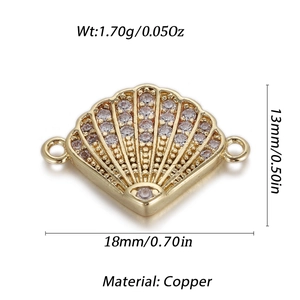 Macro detail of a shell-shaped gold copper pendant with zircons for jewelry making
