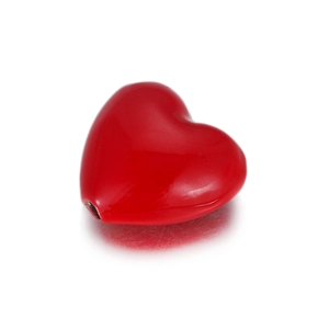 Macro shot of a red heart-shaped bead charm with glossy finish and DIY jewelry hole