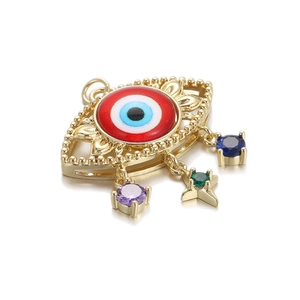 Macro detail of 14K gold plated Evil Eye pendant with colorful zircon star charms