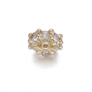 Macro shot of gold-plated geometric bead with clear cubic zirconia for DIY jewelry