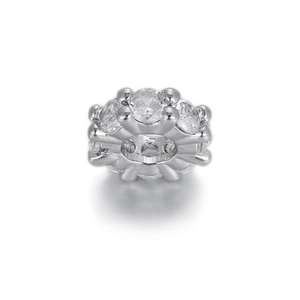 Macro view of silver geometric charm bead with micro-pave cubic zirconia settings