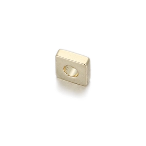 Detailed view of a gold square bead with a smooth polished finish and central round hole