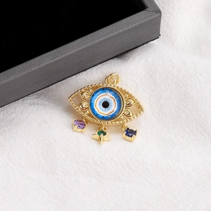 Detail of 14K gold plated Evil Eye charm with blue enamel and colorful gemstone droplets