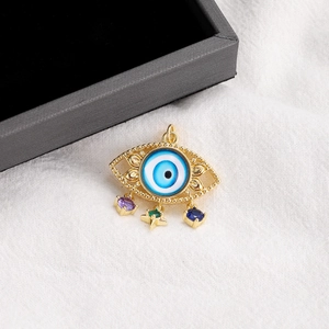 Detail of 14K gold plated evil eye pendant with three dangling multi-colored gemstones