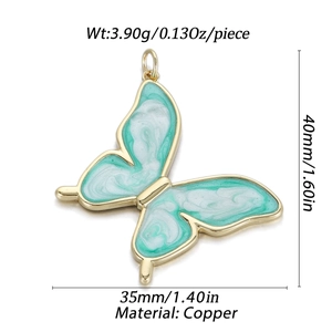 Detalle de colgante de mariposa de cobre con esmalte verde menta y dimensiones