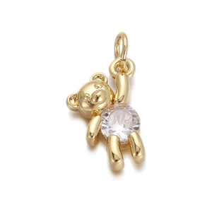 Macro shot of gold-plated bear pendant with a large sparkling cubic zirconia stone