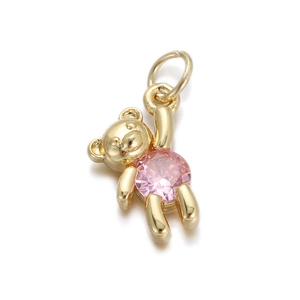 Macro view of a bear-shaped gold pendant featuring a large pink round-cut cubic zirconia