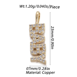 Macro shot of gold-plated BABY letter pendant with sparkling cubic zirconia stones