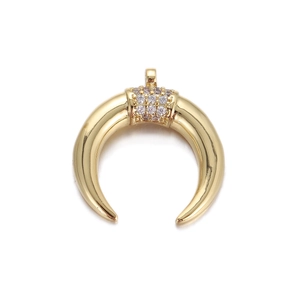 Macro detail of crescent moon pendant featuring micro-pave cubic zirconia in gold