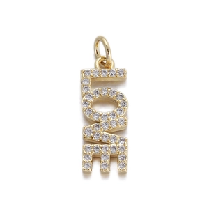 Macro detail of gold LOVE pendant with pave-set cubic zirconia for DIY jewelry