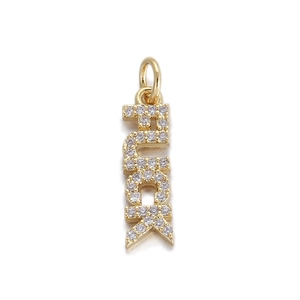 Macro detail of gold LUCK letter pendant with shimmering micro-paved cubic zirconia stones