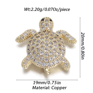 Macro shot of gold-plated copper sea turtle pendant with micro-pave cubic zirconia crystals