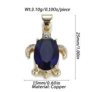 Detail of gold turtle pendant with blue gemstone and dimensions 25mm by 15mm