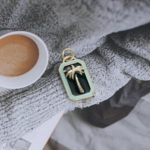 Detail of tropical gold palm tree pendant with mint green enamel border for DIY jewelry