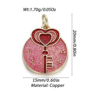 Detail of 14K gold plated heart key pendant with pink glitter and red enamel inlay