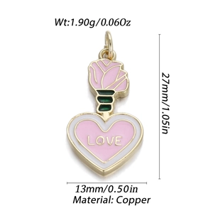 Macro detail of 14K gold plated pink heart pendant with LOVE text and floral accent