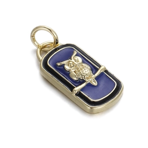 Detail showing an owl charm with blue enamel background and gold-plated textured finish