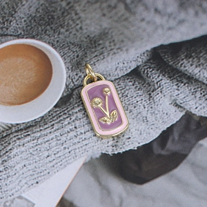 Detailed macro view of gold-plated enamel flower pendant for DIY jewelry making