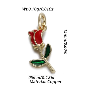 Close-up of a detailed red enamel rose pendant with green leaves and copper ring
