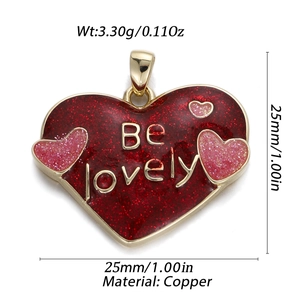 Macro detail of a 14K heart pendant in red glitter with Be Lovely engraving and copper edges