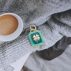 Detail of rectangular blue enamel pendant with gold clover emblem for DIY jewelry