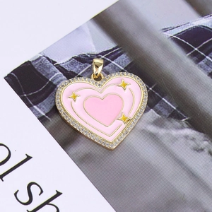 Detail of pink enamel heart pendant with gold plating and cubic zirconia border