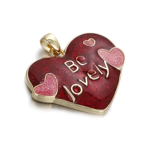 Detail of red glitter heart pendant with Be Lovely text and gold metal framing