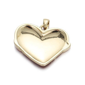 Macro detail of polished 14K gold-plated heart pendant with smooth mirror surface