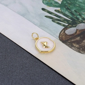 Detailopname van een gouden schelphanger met zachtroze emaille en ronde metalen ophangring