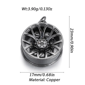 Detail view of gunmetal car wheel hub pendant with white crystals and brass texture