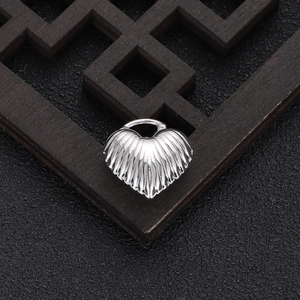Detailed view of heart pendant with radial stripe texture and silver metal finish