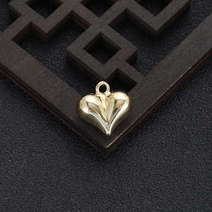 Macro view of a 14k gold-plated heart pendant with polished finish for DIY jewelry making