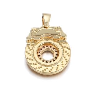 Close-up of a 14K gold plated brake disc and caliper pendant with fine mechanical details