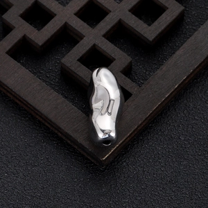 Macro detail of polished irregular 14k gold plated metal bead for DIY jewelry making