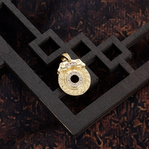 Detailed close-up of golden brake disc pendant with white zircon on vintage wood stand