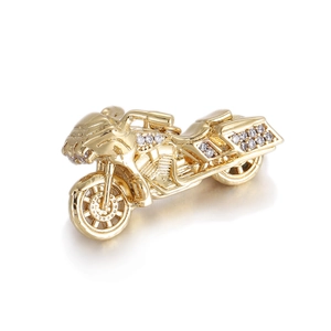 Detail of gold motorcycle pendant with white zircons showing wheels and seat lines