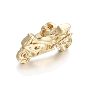 Close-up of golden motorcycle pendant with sparkling pavé helmet detail and polished finish