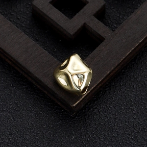 Macro view of gold irregular geometric spacer bead for DIY necklace and bracelet crafting