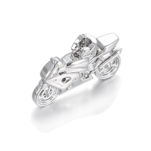 Macro view showing the detailed silver sportbike motorcycle charm with polished finish