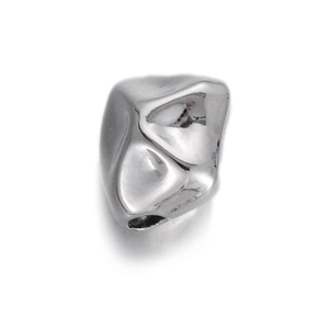 Macro shot of irregular geometric silver spacer bead with polished metallic finish and hole