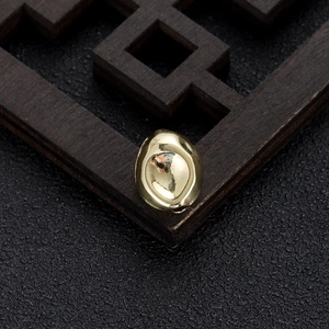 Macro shot of 14k gold-plated irregular spacer beads with polished mirror finish