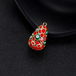 Détail macro du pendentif mauvais œil plaqué or 14K avec émail rouge et vert